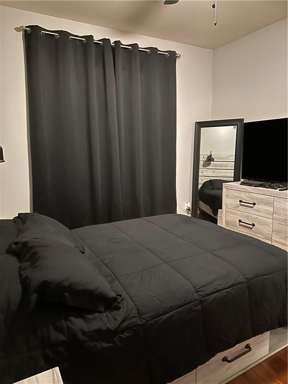 870 Mayson Turner Road Northwest, Unit 1110 Atlanta, GA 30314 - Photo 11 of 18 a bedroom with a bed and a flat tv screen