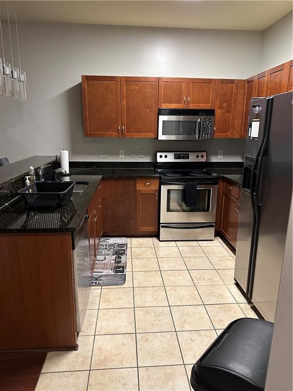 870 Mayson Turner Road Northwest, Unit 1110 Atlanta, GA 30314 - Photo 13 of 18 a kitchen with a sink a stove and black cabinets