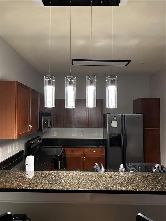 870 Mayson Turner Road Northwest, Unit 1110 Atlanta, GA 30314 - Photo 14 of 18 a kitchen with stainless steel appliances granite countertop a sink a stove and a refrigerator