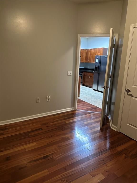 870 Mayson Turner Road Northwest, Unit 1110 Atlanta, GA 30314 - Photo 17 of 18 an empty room with wooden floor and entrance