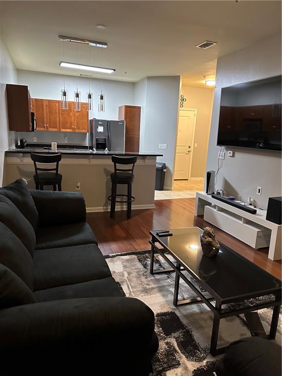 870 Mayson Turner Road Northwest, Unit 1110 Atlanta, GA 30314 - Photo 4 of 18 a living room with furniture and a flat screen tv