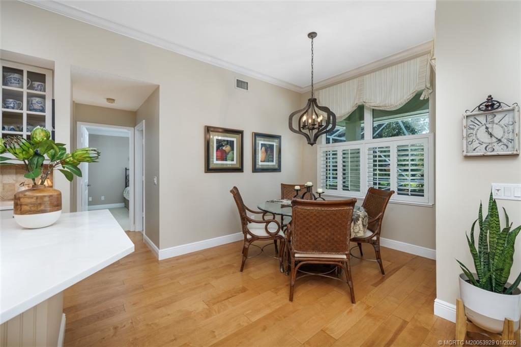 1976 Southwest Oak Ridge Road Palm City, FL 34990 - Photo 14 of 65 a view of a dining room with furniture window and wooden floor