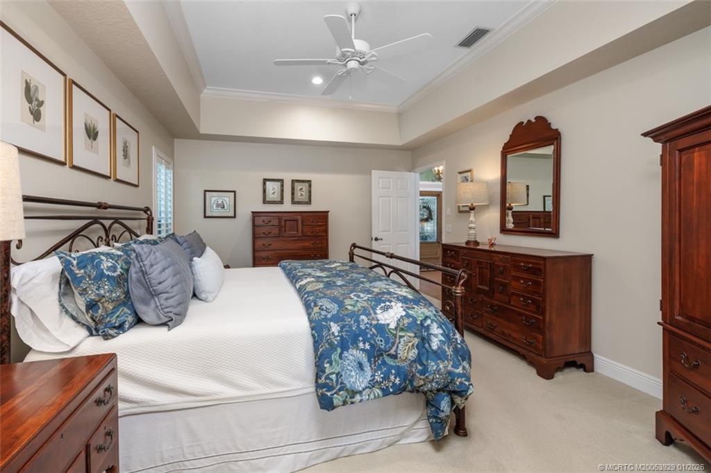 1976 Southwest Oak Ridge Road Palm City, FL 34990 - Photo 20 of 65 a bedroom with a large bed and a dresser