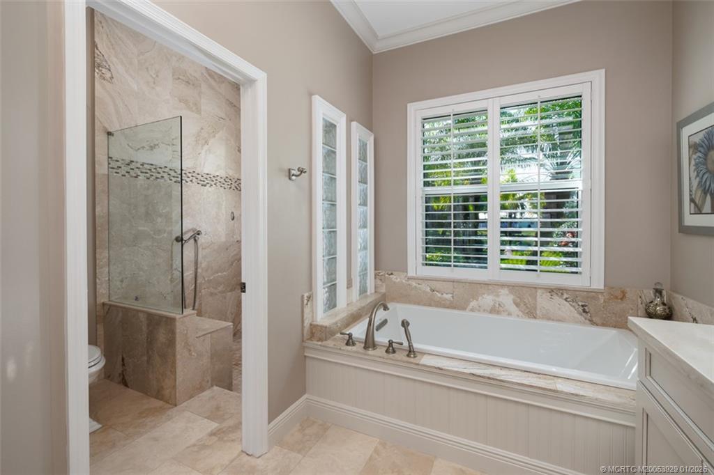 1976 Southwest Oak Ridge Road Palm City, FL 34990 - Photo 22 of 65 a bathroom with a bathtub and a shower