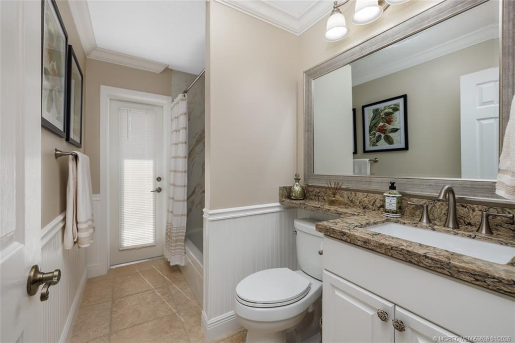 1976 Southwest Oak Ridge Road Palm City, FL 34990 - Photo 25 of 65 a bathroom with a granite countertop toilet sink and mirror