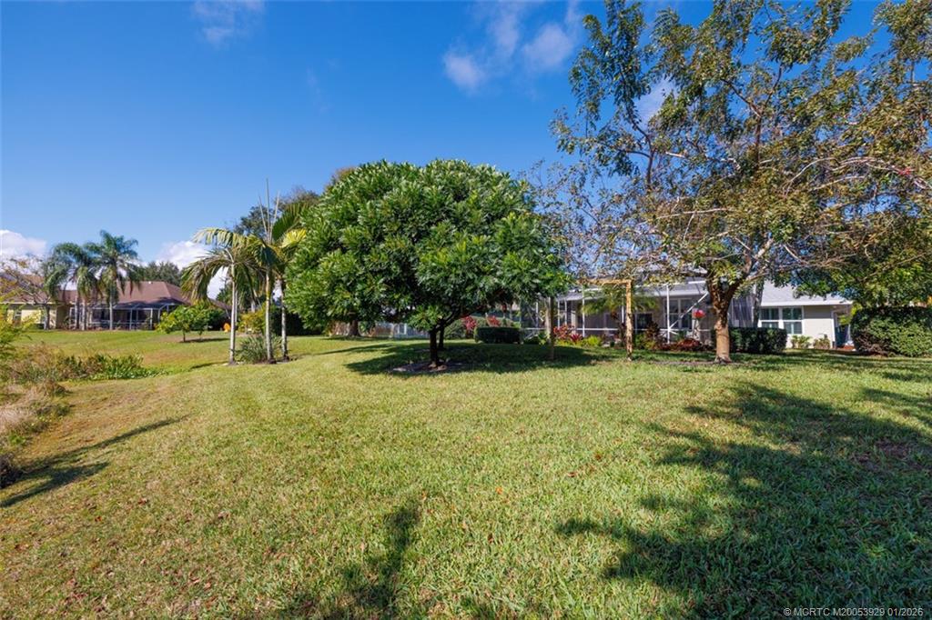 1976 Southwest Oak Ridge Road Palm City, FL 34990 - Photo 41 of 65 a front view of a house with a yard