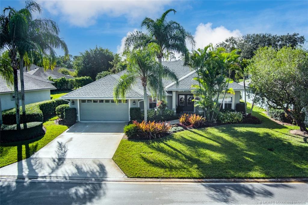 1976 Southwest Oak Ridge Road Palm City, FL 34990 - Photo 43 of 65 front view of house with a yard and potted plants