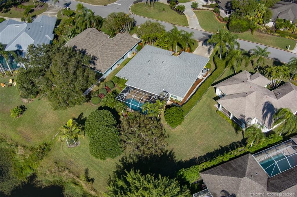1976 Southwest Oak Ridge Road Palm City, FL 34990 - Photo 45 of 65 an aerial view of a house with a yard and lake view