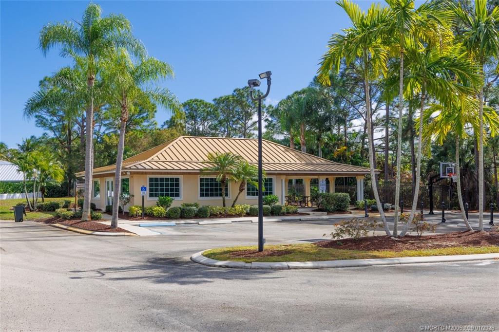 1976 Southwest Oak Ridge Road Palm City, FL 34990 - Photo 53 of 65 a front view of a house with a yard table and chairs