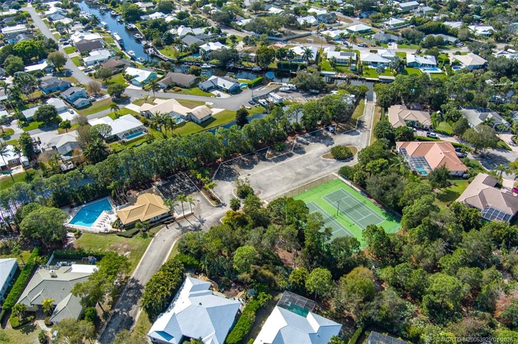 1976 Southwest Oak Ridge Road Palm City, FL 34990 - Photo 64 of 65 an aerial view of residential houses with outdoor space and trees