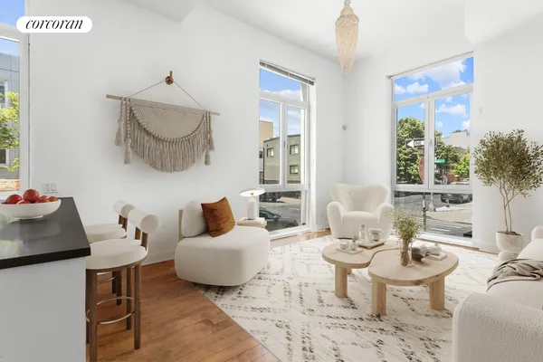 a living room with furniture a rug and a large window