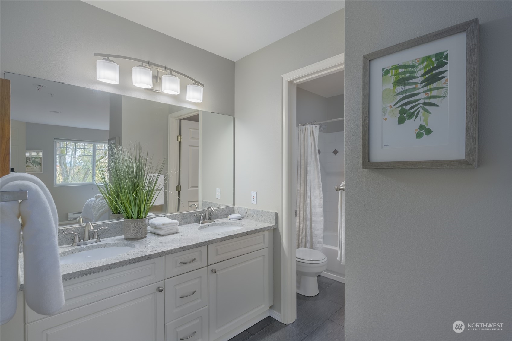 18501 Southeast Newport Way, Unit H236 Issaquah, WA 98027 - Photo 13 of 25 a bathroom with a granite countertop sink and a mirror