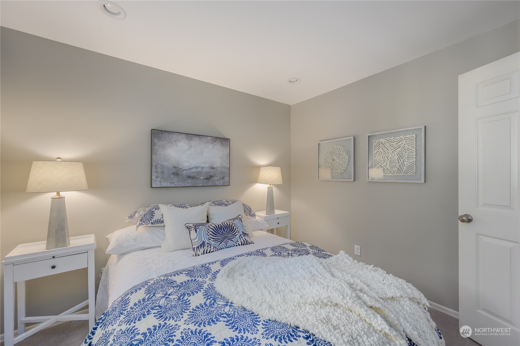 18501 Southeast Newport Way, Unit H236 Issaquah, WA 98027 - Photo 16 of 25 a bedroom with bed and a lamp on dresser