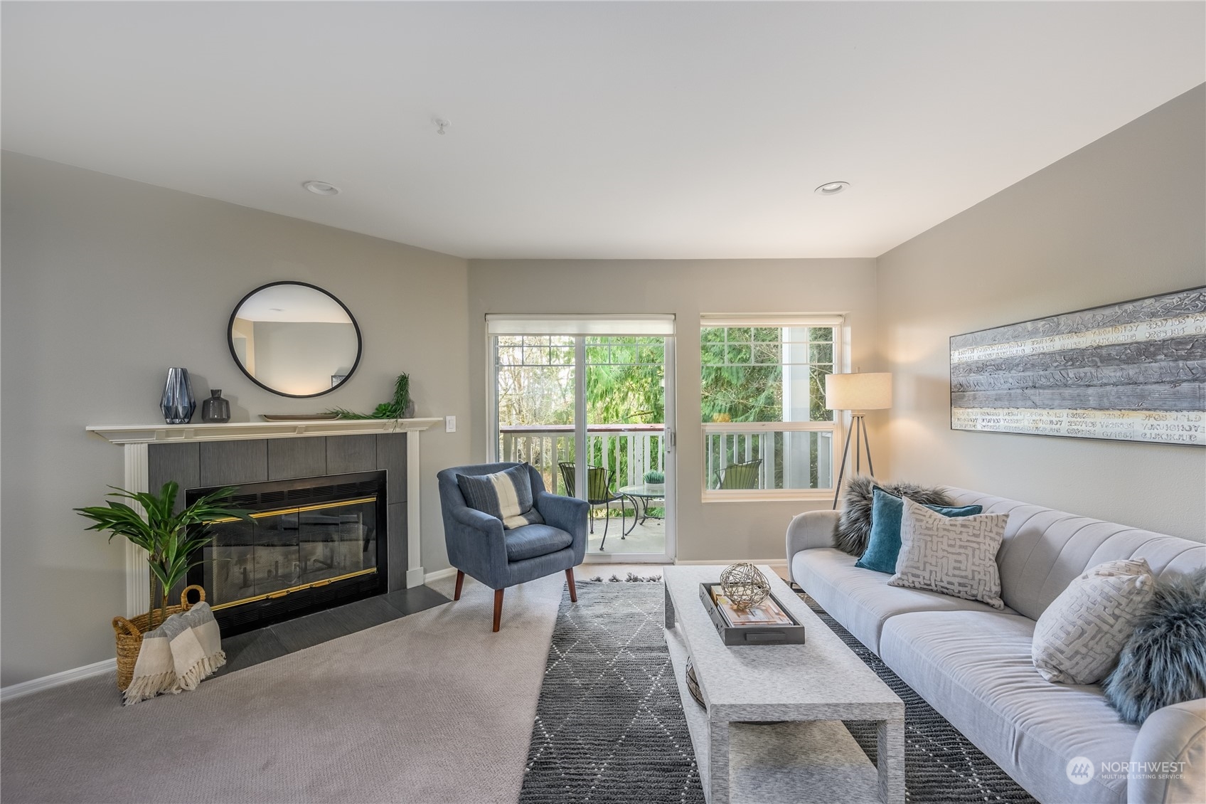18501 Southeast Newport Way, Unit H236 Issaquah, WA 98027 - Photo 2 of 25 a living room with furniture a fireplace a window and a flat screen tv