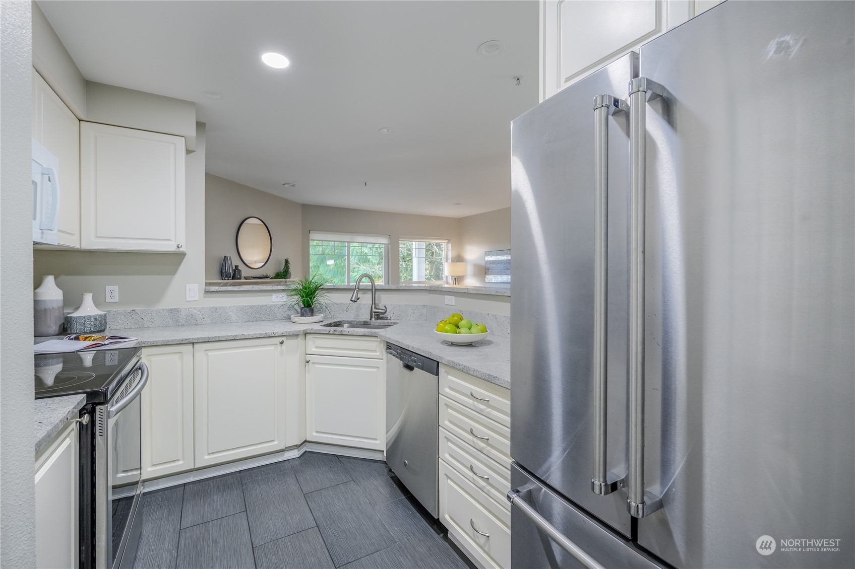 18501 Southeast Newport Way, Unit H236 Issaquah, WA 98027 - Photo 8 of 25 a kitchen with stainless steel appliances granite countertop a refrigerator and a sink