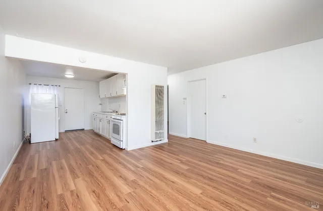 a view of a kitchen with wooden floor