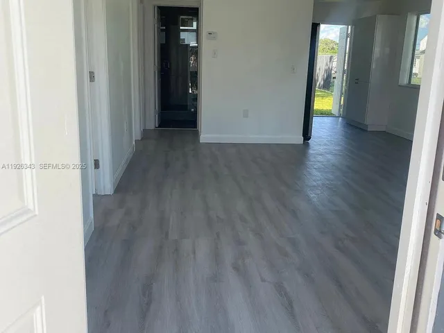 a view of hallway with wooden floor