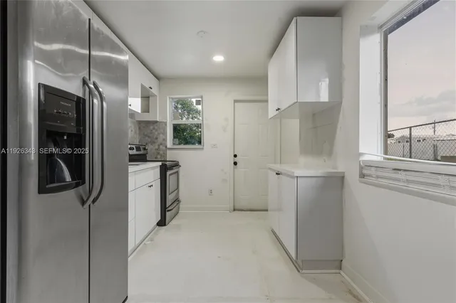 a kitchen with a refrigerator and a sink