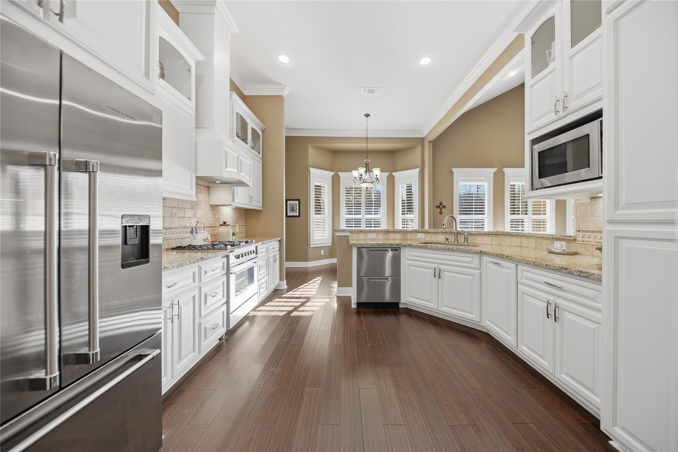 110 Windy Acres Road Brenham, TX 77833 - Photo 13 of 38 a large kitchen with stainless steel appliances and white cabinets