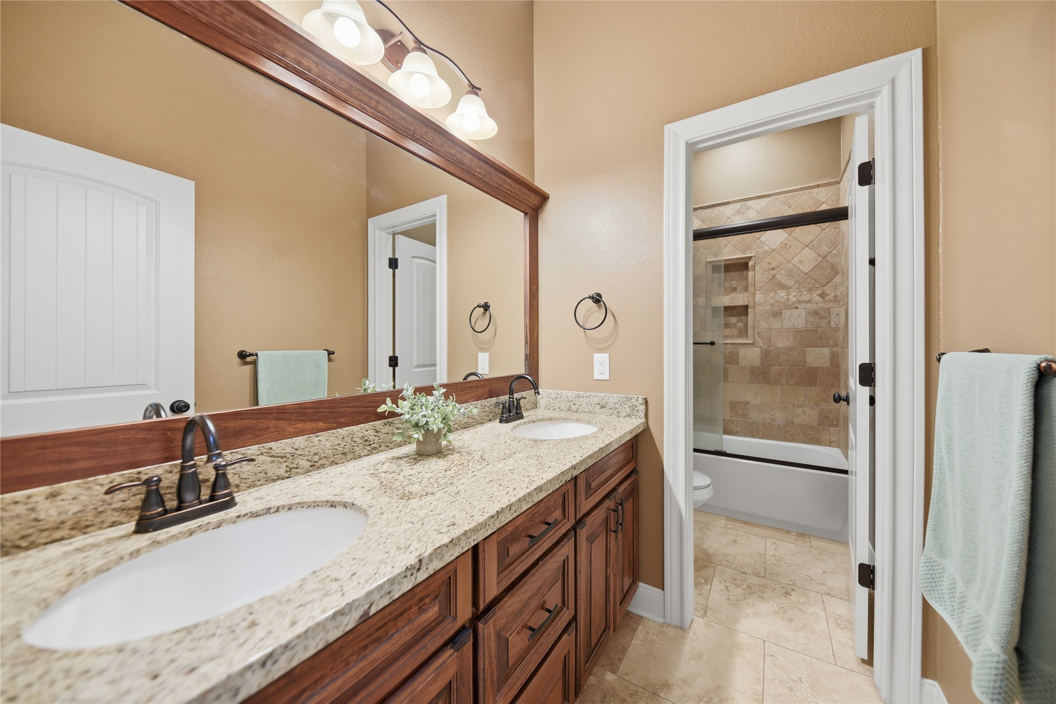 110 Windy Acres Road Brenham, TX 77833 - Photo 25 of 38 a bathroom with a granite countertop sink and a mirror