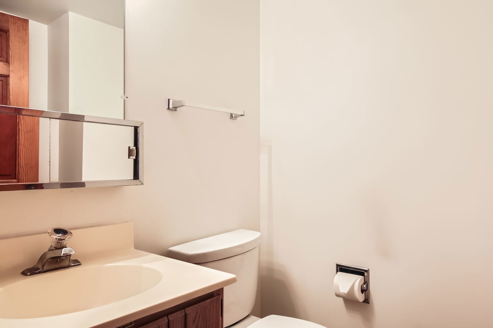 4665 Olmstead Drive Hoffman Estates, IL 60192 - Photo 29 of 42 a bathroom with a sink a toilet and mirror