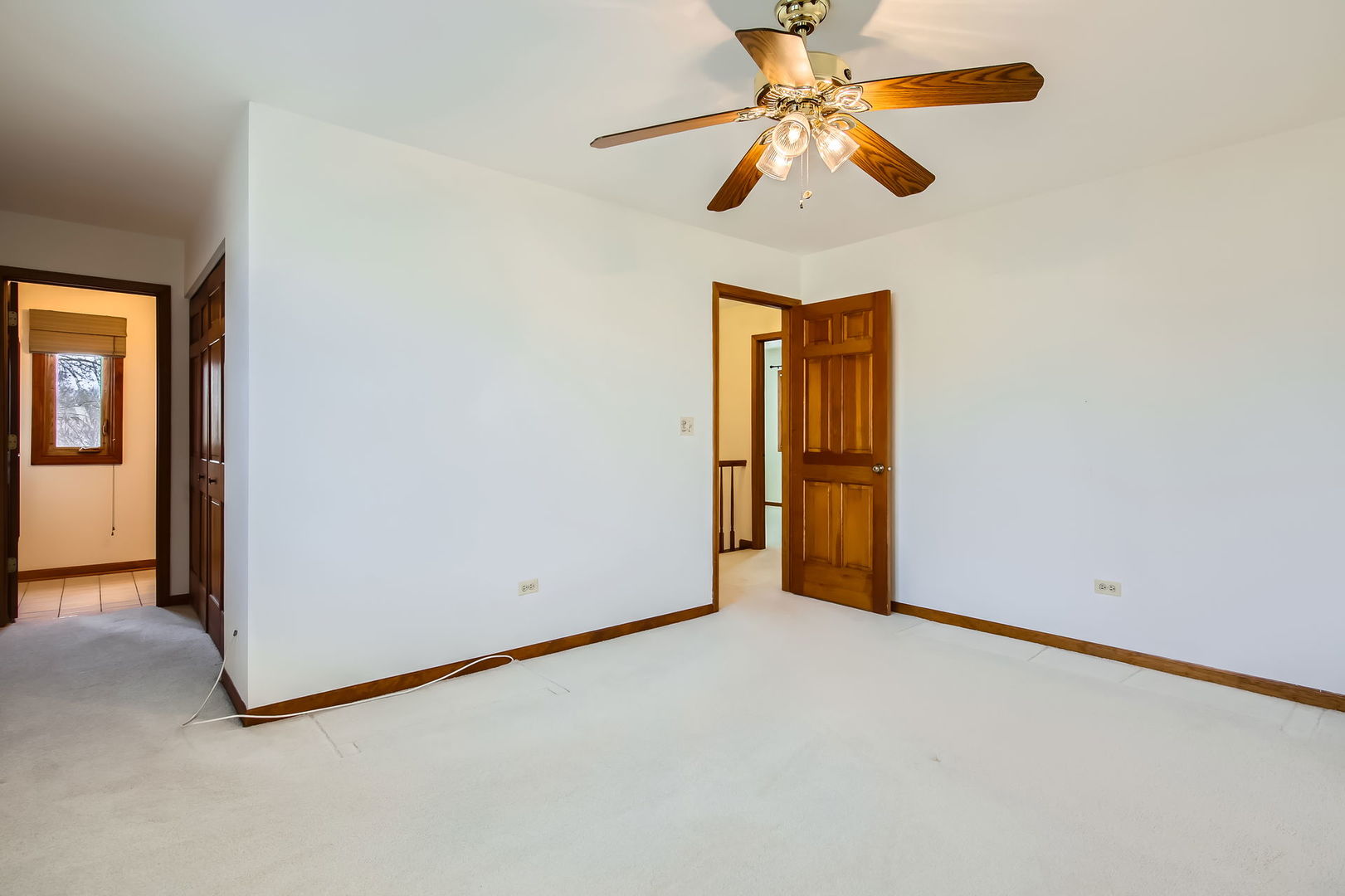 4665 Olmstead Drive Hoffman Estates, IL 60192 - Photo 32 of 42 an empty room with closet and a chandelier fan