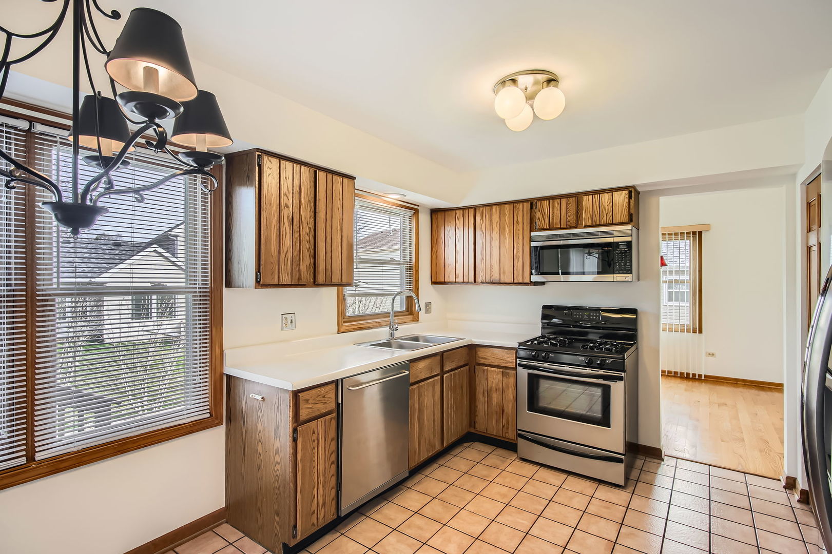 4665 Olmstead Drive Hoffman Estates, IL 60192 - Photo 4 of 42 a kitchen with stainless steel appliances a stove a sink and a microwave
