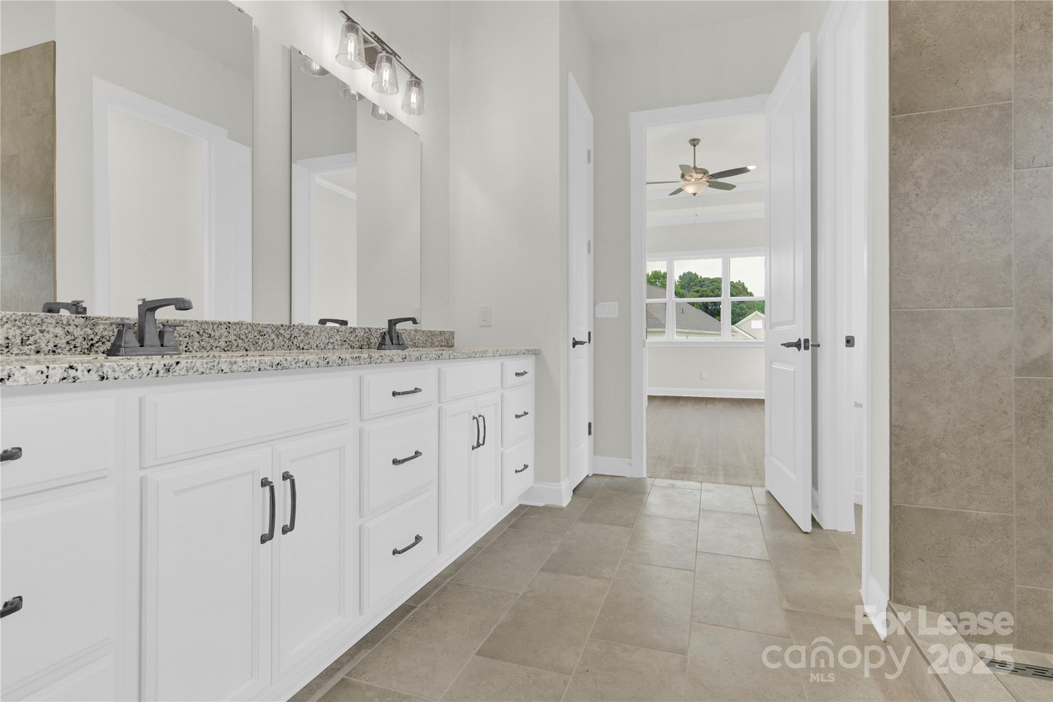 4715 Anise Circle, Unit 40 Sherrills Ford, NC 28673 - Photo 12 of 20 a spacious bathroom with a granite countertop sink and a mirror