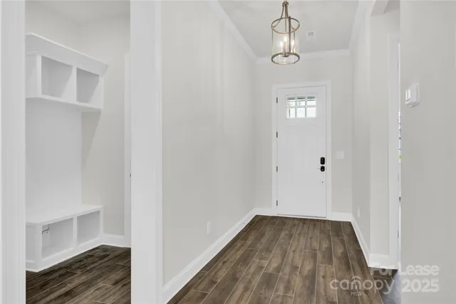 a view of a hallway with wooden floor and staircase