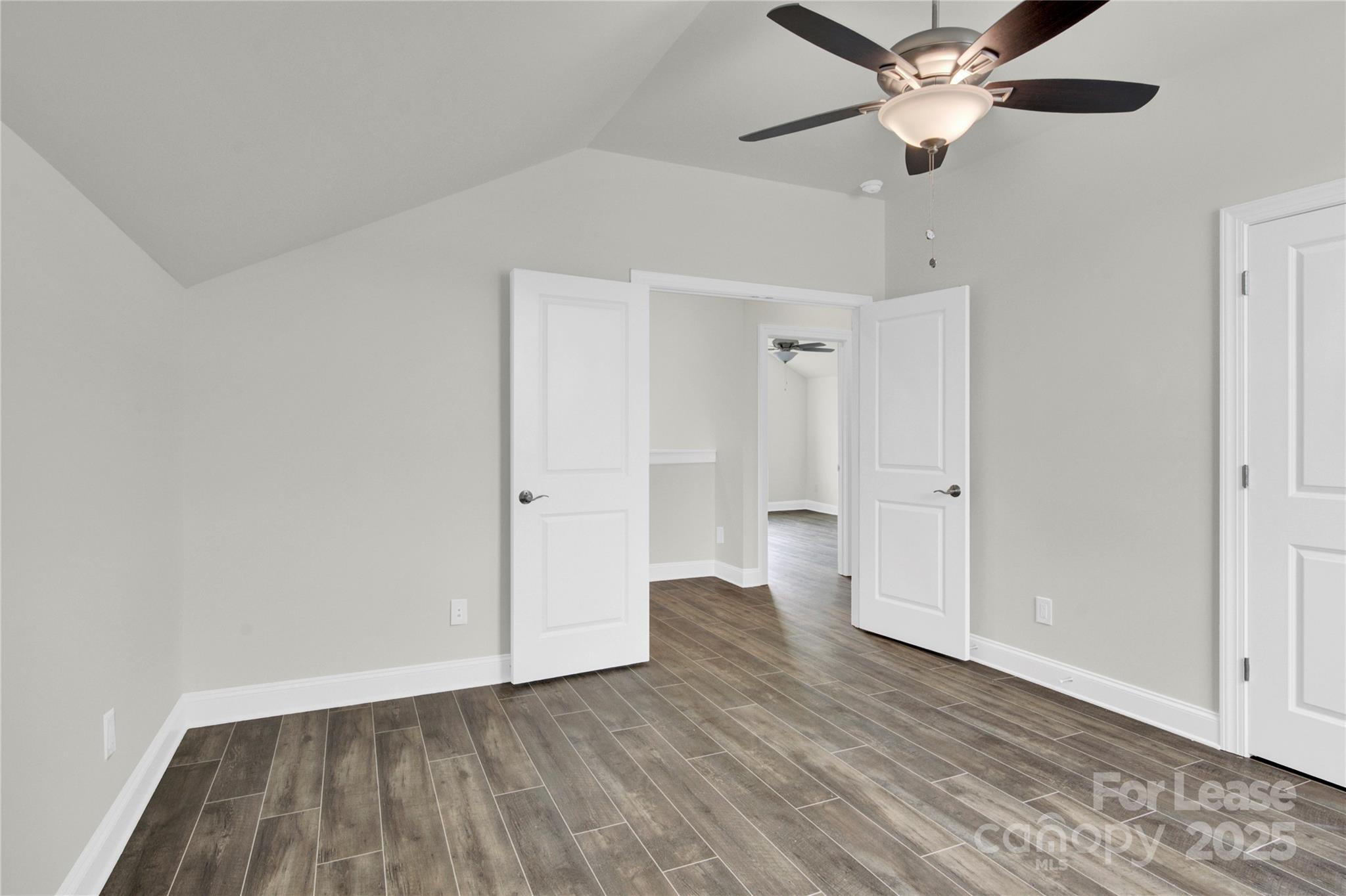 4715 Anise Circle, Unit 40 Sherrills Ford, NC 28673 - Photo 17 of 20 an empty room with wooden floor and ceiling fan