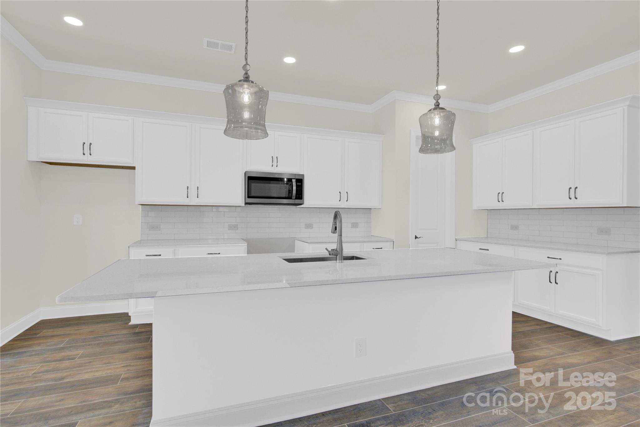 4715 Anise Circle, Unit 40 Sherrills Ford, NC 28673 - Photo 5 of 20 a kitchen with kitchen island a sink and white cabinets