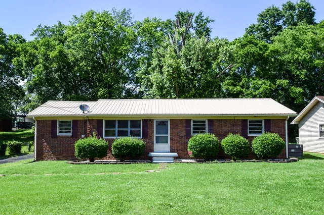 a front view of a house with a yard