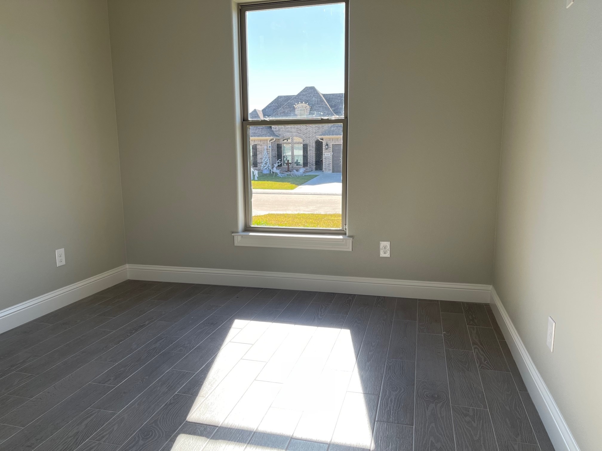 10440 Dominion Ranch Drive Port Arthur, TX 77640 - Photo 16 of 22 an empty room with wooden floor and windows