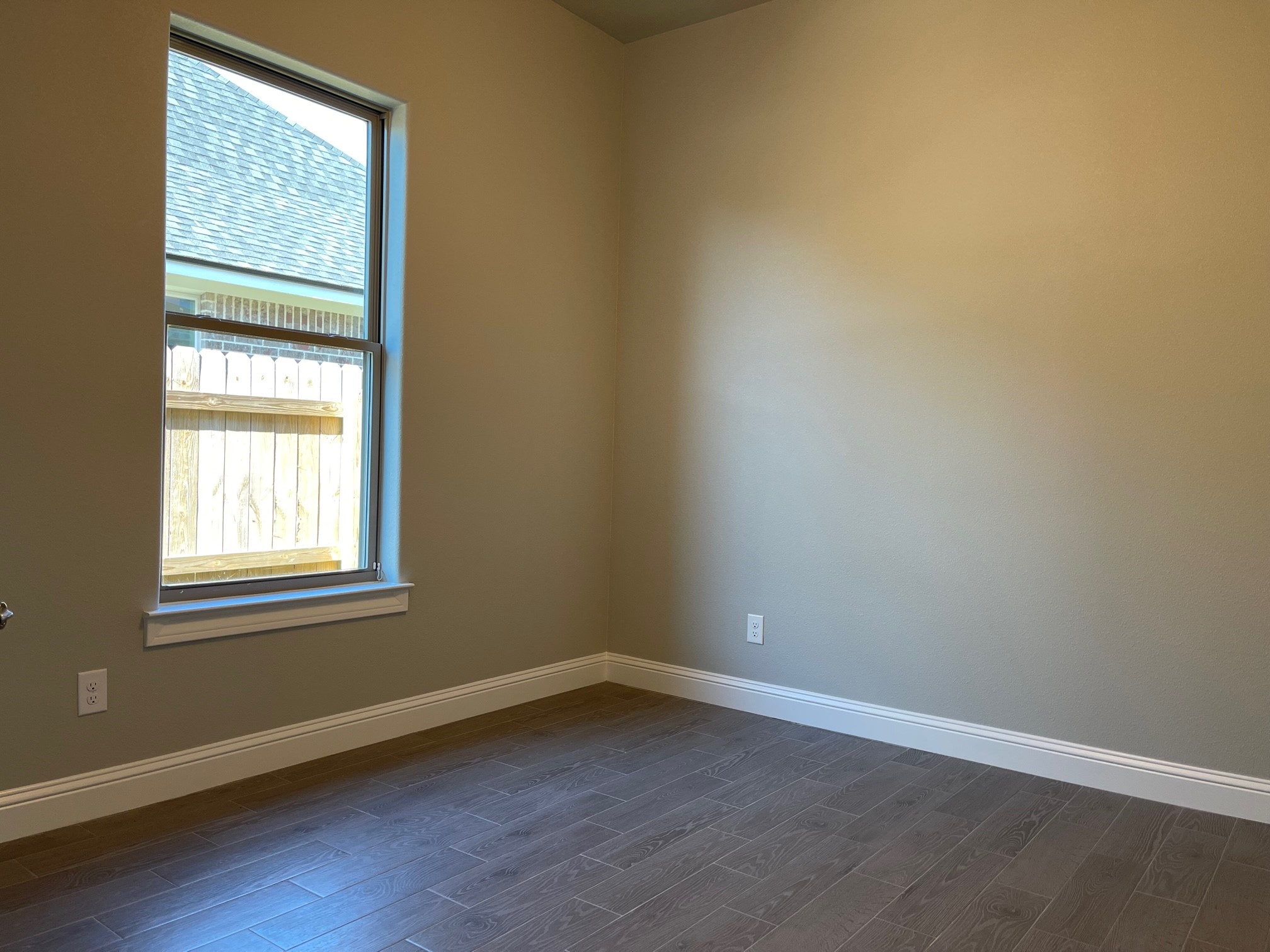 10440 Dominion Ranch Drive Port Arthur, TX 77640 - Photo 19 of 22 an empty room with wooden floor and windows