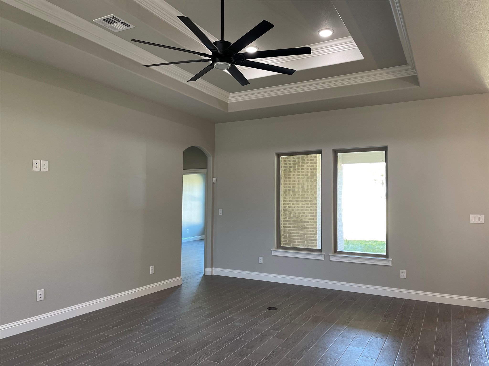10440 Dominion Ranch Drive Port Arthur, TX 77640 - Photo 10 of 22 an empty room with wooden floor and windows