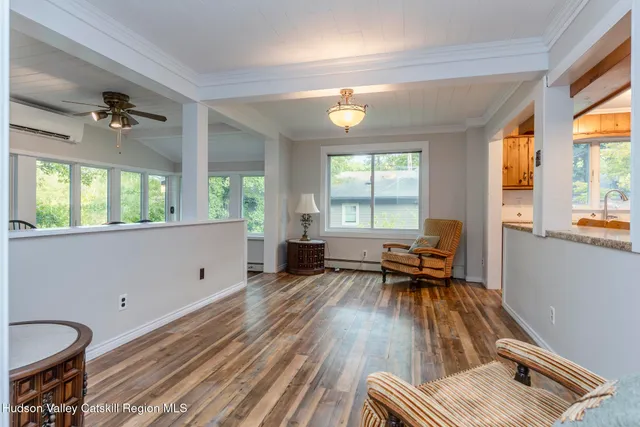 a view of a dining room with furniture and wooden floor