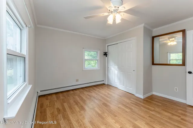 a view of entryway and hall with wooden floor