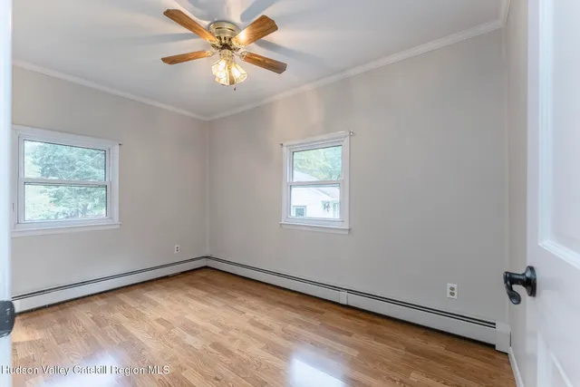 a large kitchen with a large window a sink and cabinets