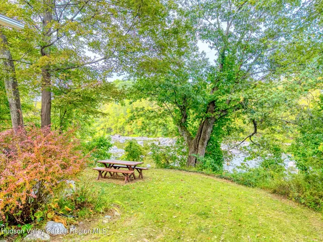 a backyard of a house with yard table and chairs