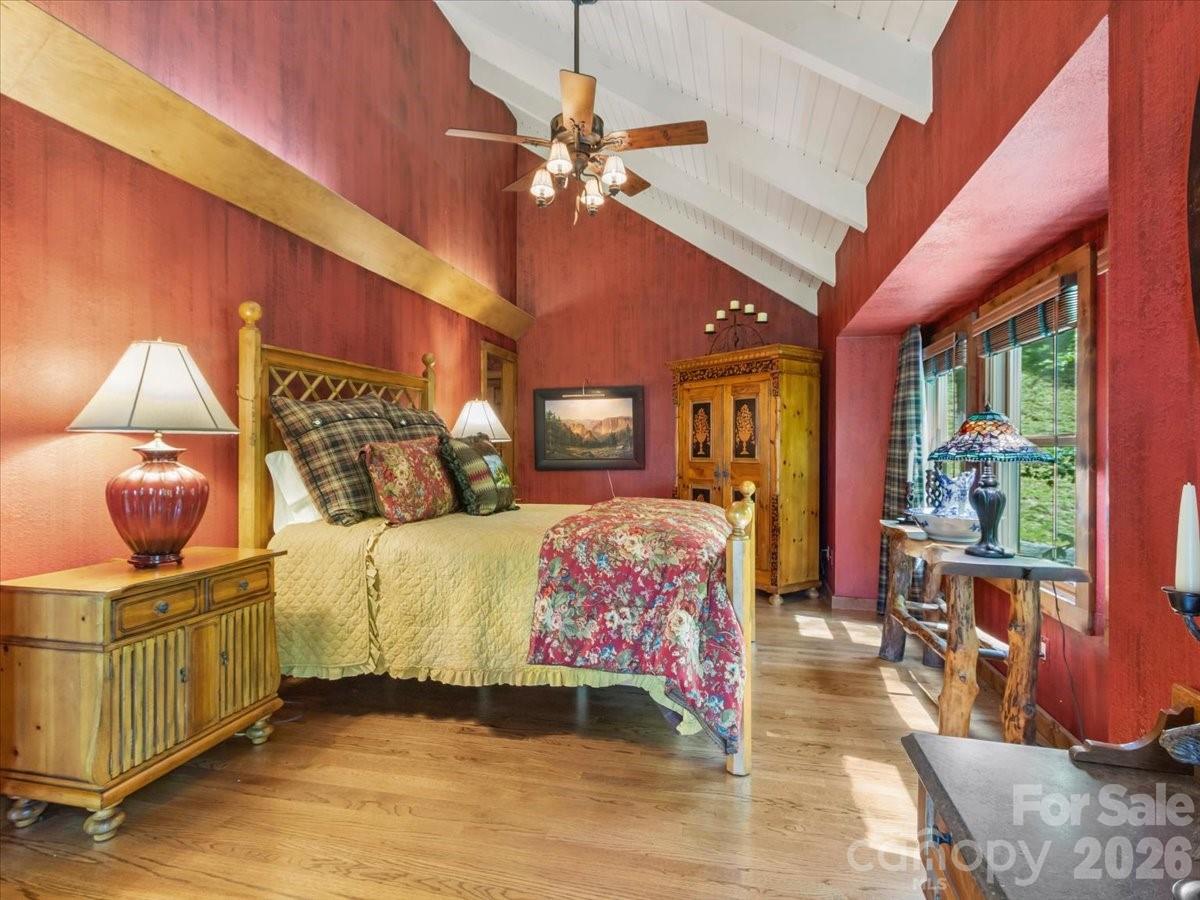 121 Ivy Ridge Road Burnsville, NC 28714 - Photo 17 of 48 a bedroom with a bed and ceiling fan