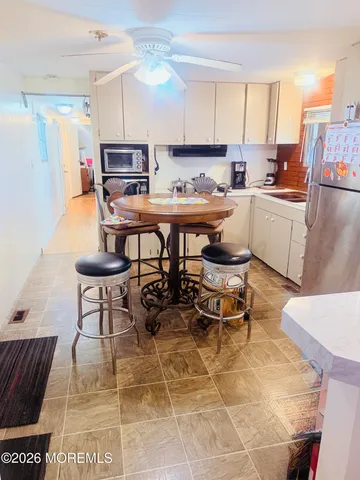a kitchen with stainless steel appliances kitchen island granite countertop a sink and a stove