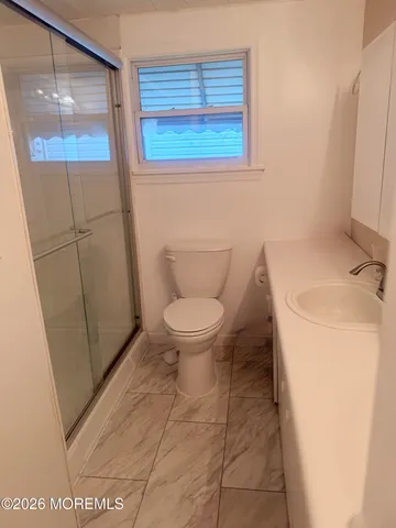 a bathroom with a toilet and a shower