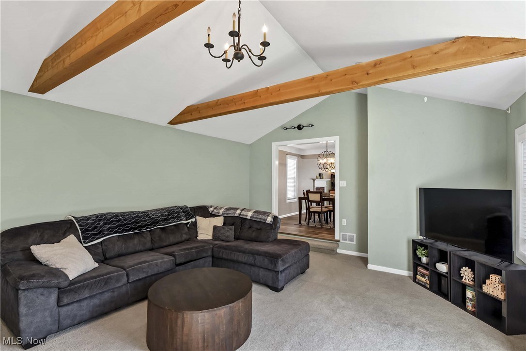 1204 Brainard Road Lyndhurst, OH 44124 - Photo 18 of 34 Family room featuring vaulted ceiling with beams, an inviting chandelier, and carpet