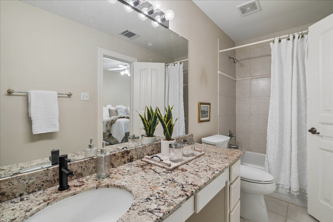 14530 Millhouse Road Pinehurst, TX 77362 - Photo 24 of 46 Secondary bathroom with granite countertops and tub/shower combination, positioned with convenient access from the adjoining bedroom.