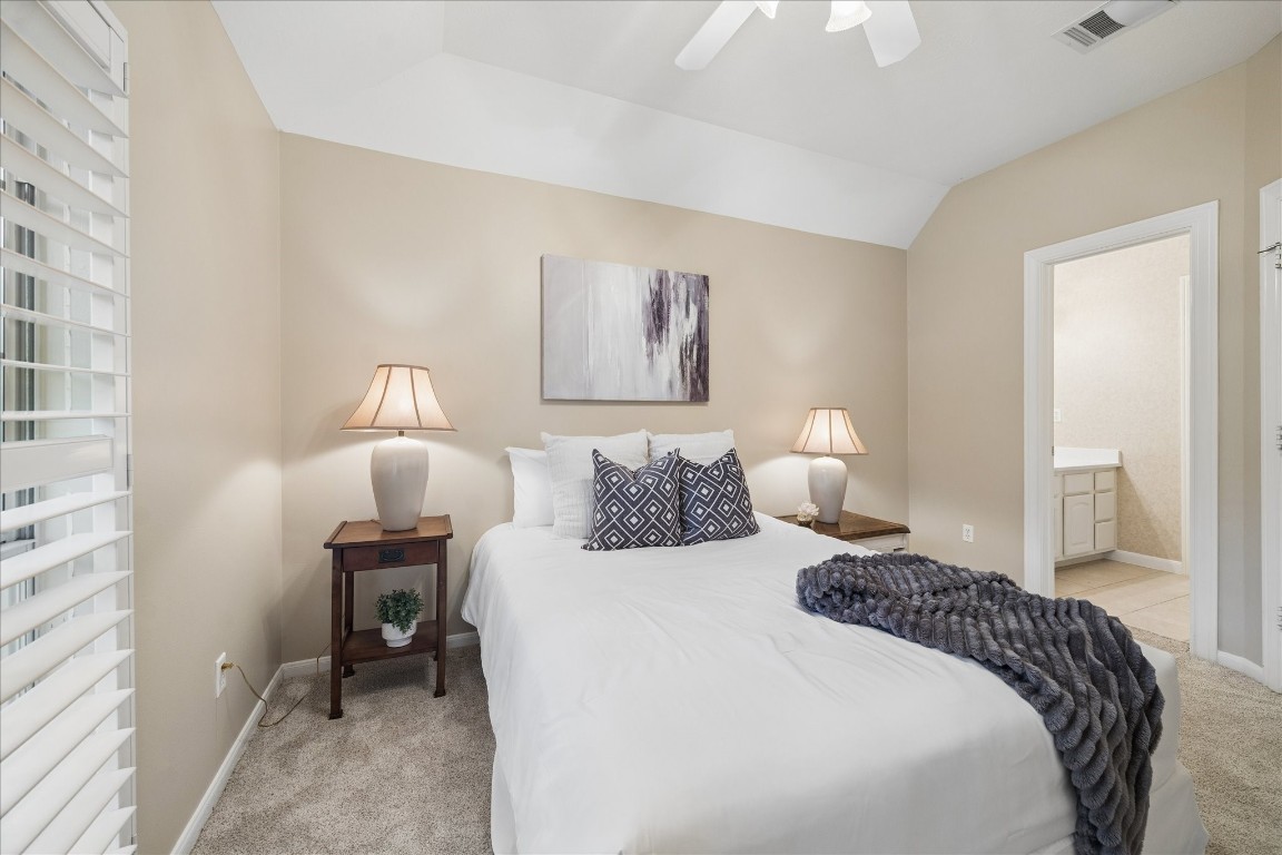 14530 Millhouse Road Pinehurst, TX 77362 - Photo 26 of 46 Alternate view of the bedroom with direct access to a shared bath, featuring a private sink area for added functionality.