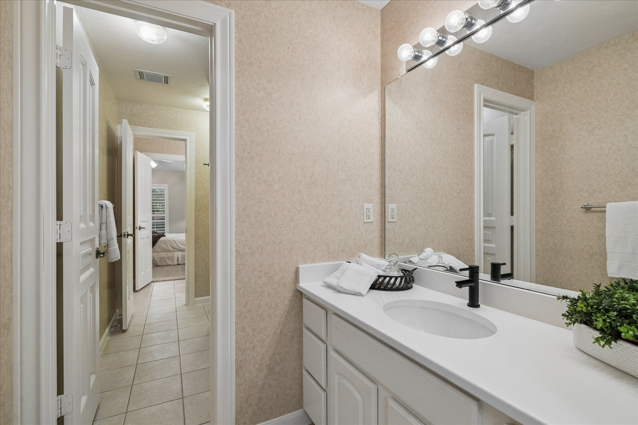 14530 Millhouse Road Pinehurst, TX 77362 - Photo 28 of 43 Another view of the Hollywood bathroom highlighting the private vanity area and access to the shared tub/shower space.