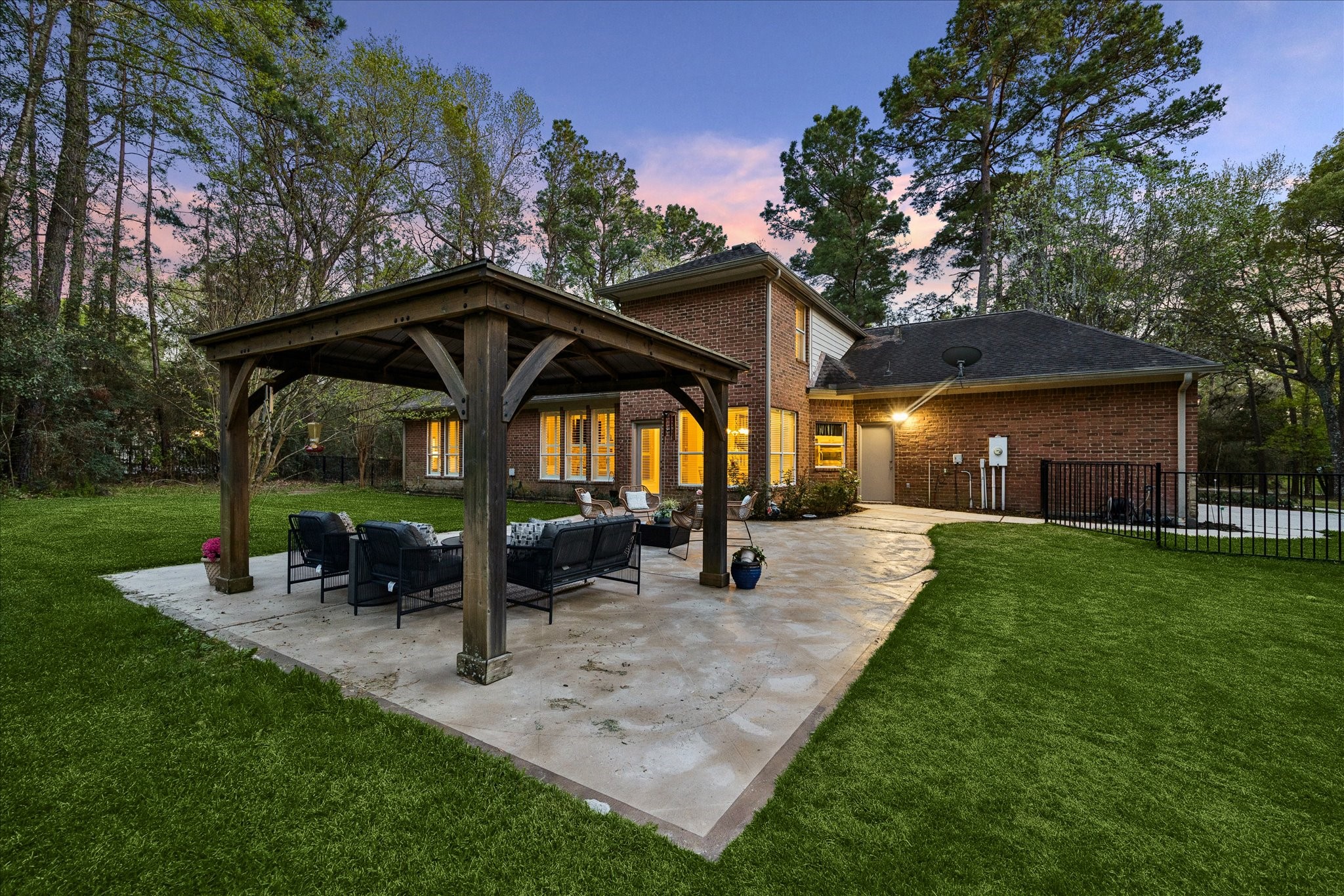 14530 Millhouse Road Pinehurst, TX 77362 - Photo 32 of 43 Extended patio with covered pavilion seating area, providing generous space for outdoor entertaining, set on a spacious 1.67 (+/-) acre property.