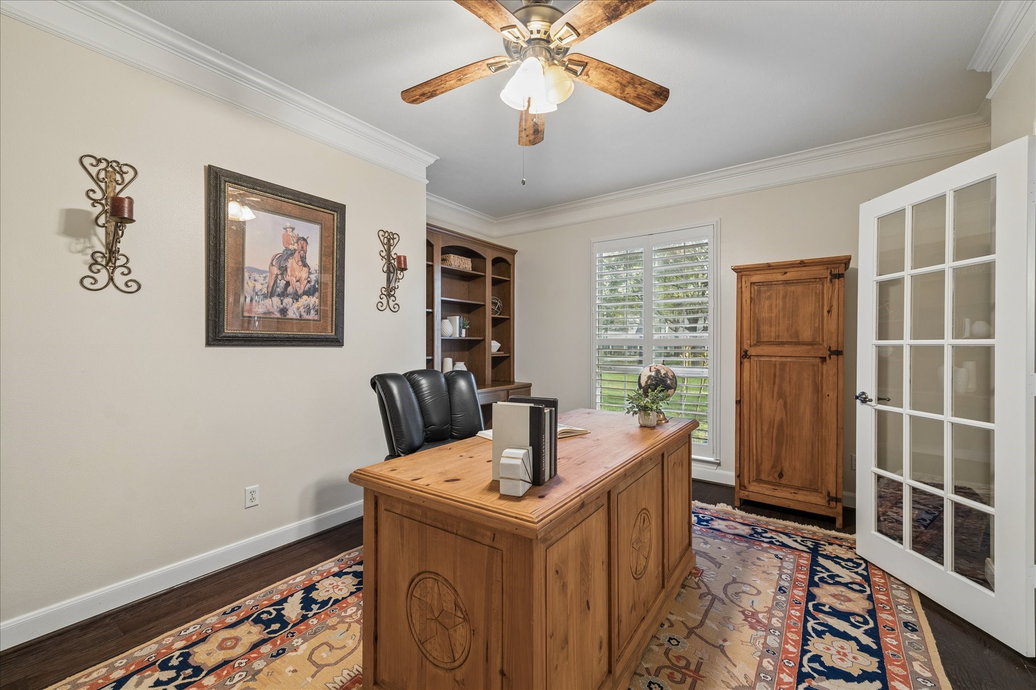 14530 Millhouse Road Pinehurst, TX 77362 - Photo 5 of 43 Private home office just off the entry with wood flooring, built-in shelving, French doors, crown molding, and a window for natural light finished with plantation shutters.