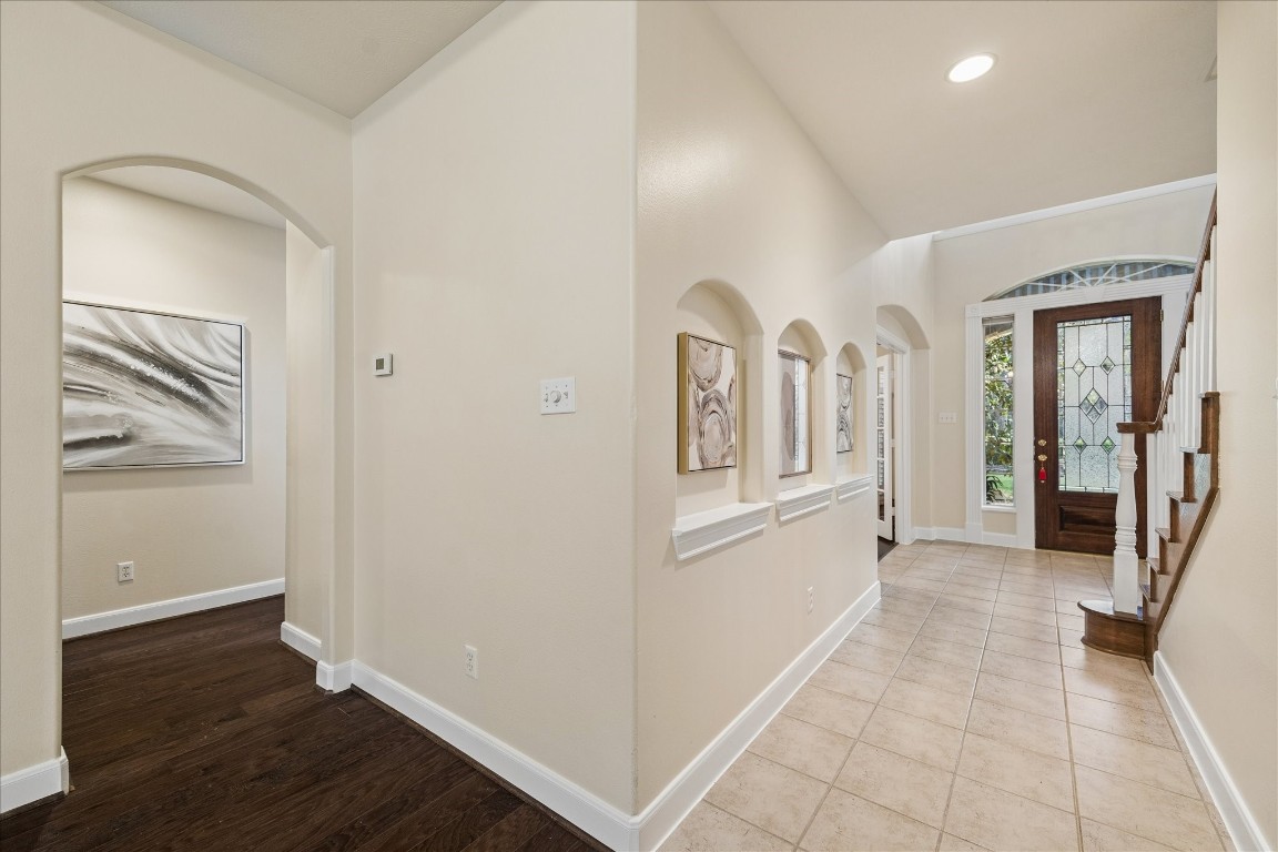 14530 Millhouse Road Pinehurst, TX 77362 - Photo 8 of 46 Entry view showcasing the foyer with high ceilings, arched architectural niches, tile flooring, and access to the private office.