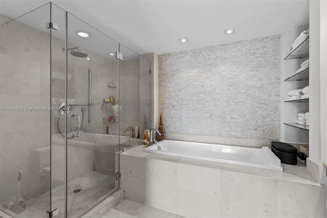 a bathroom with a bathtub and a shower